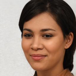 Joyful latino young-adult female with medium  brown hair and brown eyes