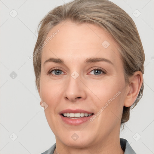 Joyful white adult female with medium  brown hair and grey eyes