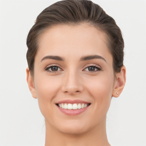 Joyful white young-adult female with short  brown hair and brown eyes