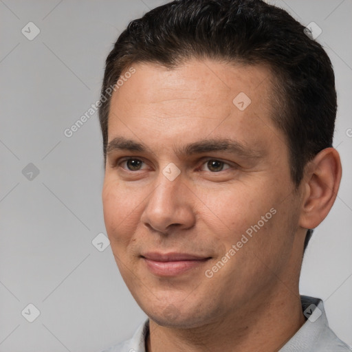 Joyful white adult male with short  brown hair and brown eyes