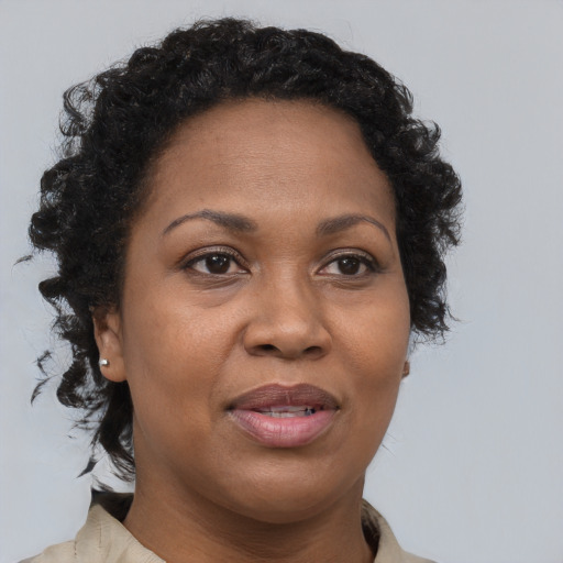 Joyful black adult female with short  brown hair and brown eyes