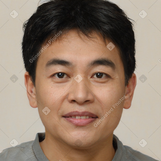 Joyful asian young-adult male with short  brown hair and brown eyes