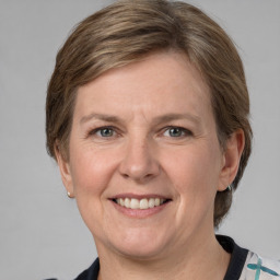 Joyful white adult female with medium  brown hair and grey eyes