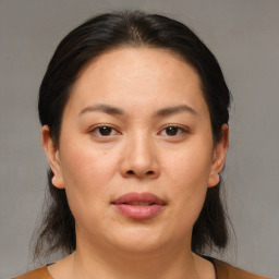 Joyful white adult female with medium  brown hair and brown eyes