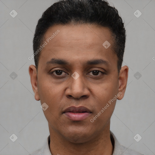 Joyful black young-adult male with short  black hair and brown eyes