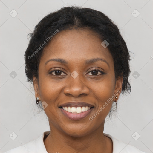 Joyful black young-adult female with short  brown hair and brown eyes