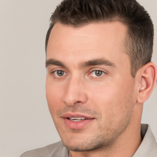 Joyful white young-adult male with short  brown hair and brown eyes