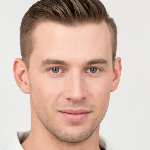 Joyful white young-adult male with short  brown hair and grey eyes