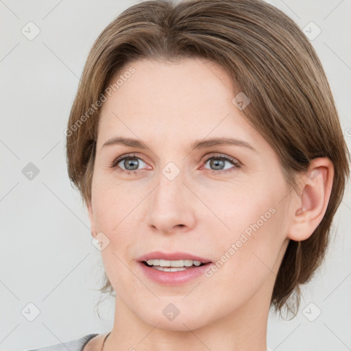 Joyful white young-adult female with medium  brown hair and blue eyes