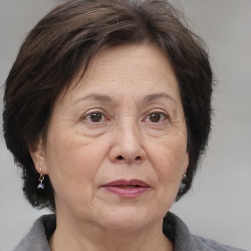 Joyful white middle-aged female with medium  brown hair and brown eyes