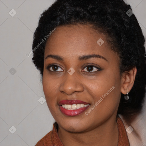 Joyful black young-adult female with long  black hair and brown eyes