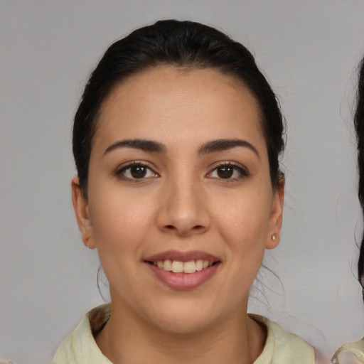 Joyful white young-adult female with medium  brown hair and brown eyes