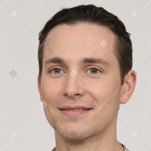 Joyful white adult male with short  brown hair and brown eyes