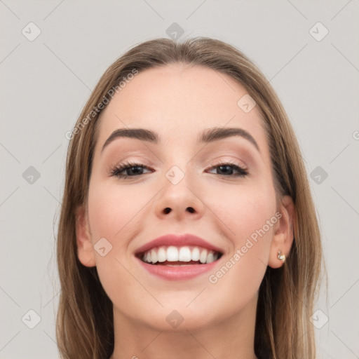 Joyful white young-adult female with long  brown hair and brown eyes