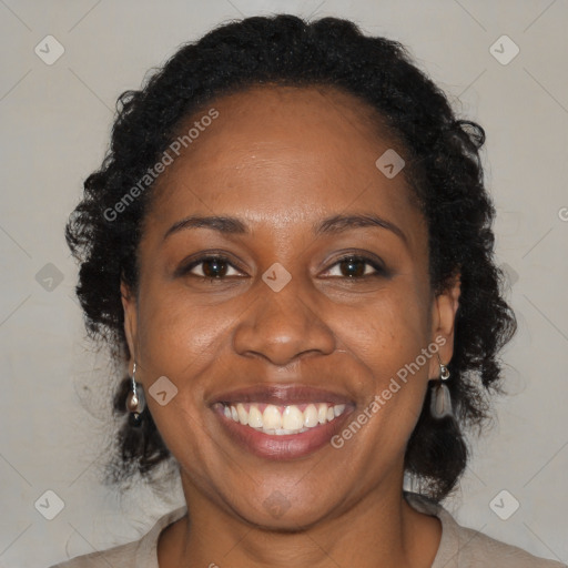 Joyful black adult female with medium  brown hair and brown eyes