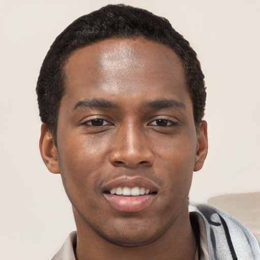 Joyful black young-adult male with short  black hair and brown eyes