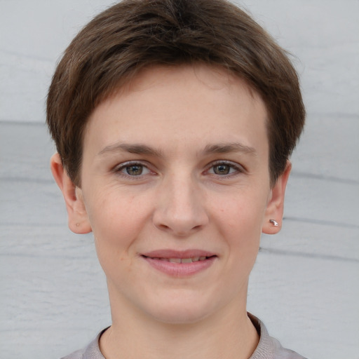 Joyful white young-adult female with short  brown hair and grey eyes