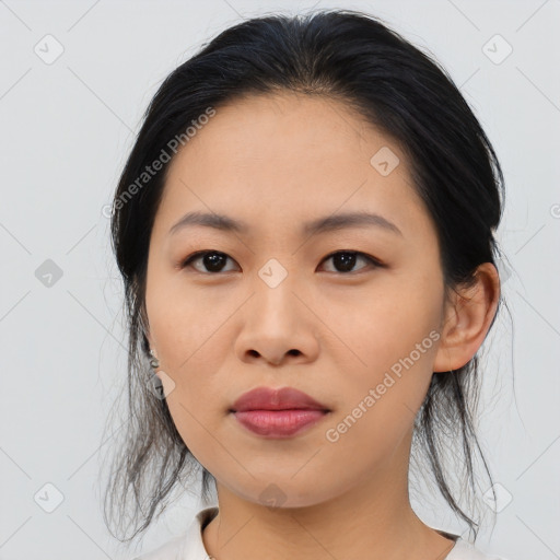 Joyful asian young-adult female with medium  black hair and brown eyes