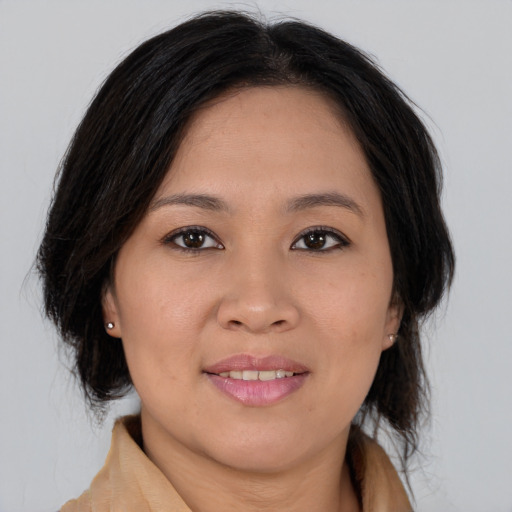 Joyful asian young-adult female with long  brown hair and brown eyes