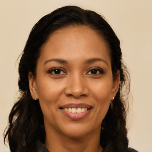 Joyful latino young-adult female with long  brown hair and brown eyes