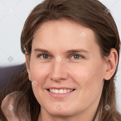 Joyful white young-adult female with long  brown hair and grey eyes