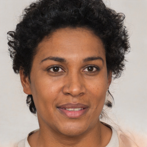 Joyful black adult female with short  brown hair and brown eyes
