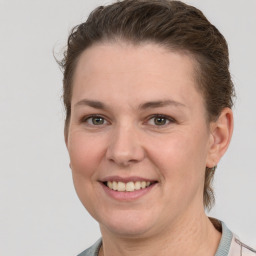 Joyful white adult female with short  brown hair and grey eyes