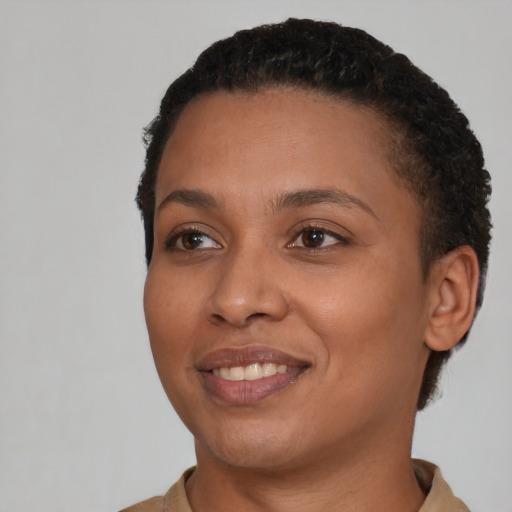 Joyful black young-adult female with short  brown hair and brown eyes