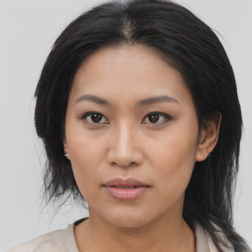 Joyful asian young-adult female with medium  brown hair and brown eyes