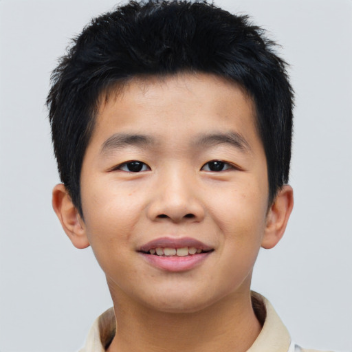 Joyful asian child male with short  brown hair and brown eyes
