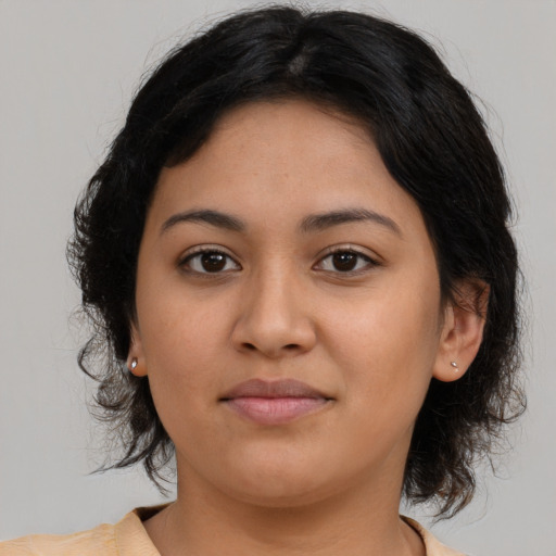 Joyful latino young-adult female with medium  brown hair and brown eyes