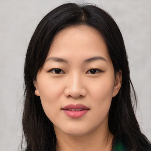 Joyful asian young-adult female with long  black hair and brown eyes