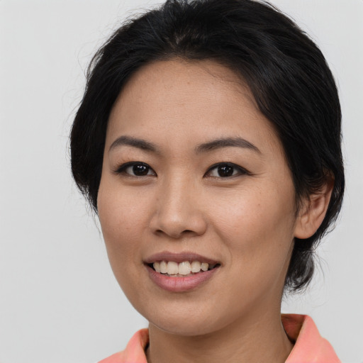 Joyful asian young-adult female with medium  brown hair and brown eyes