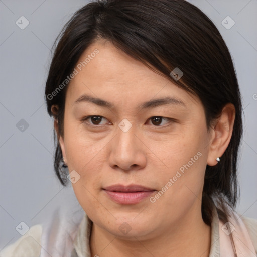 Joyful asian adult female with medium  brown hair and brown eyes