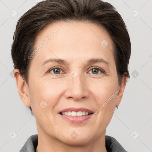 Joyful white adult female with short  brown hair and grey eyes