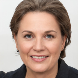 Joyful white adult female with medium  brown hair and grey eyes