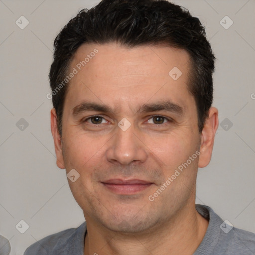 Joyful white adult male with short  black hair and brown eyes