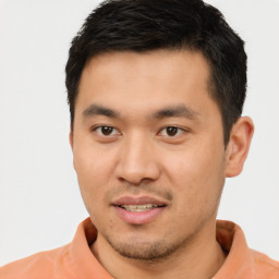 Joyful latino young-adult male with short  brown hair and brown eyes