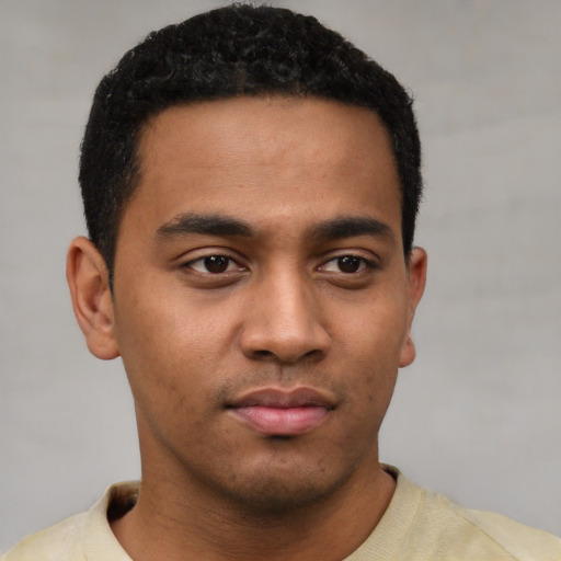 Neutral latino young-adult male with short  black hair and brown eyes
