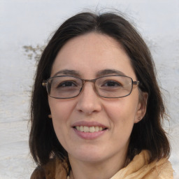 Joyful white adult female with medium  brown hair and brown eyes