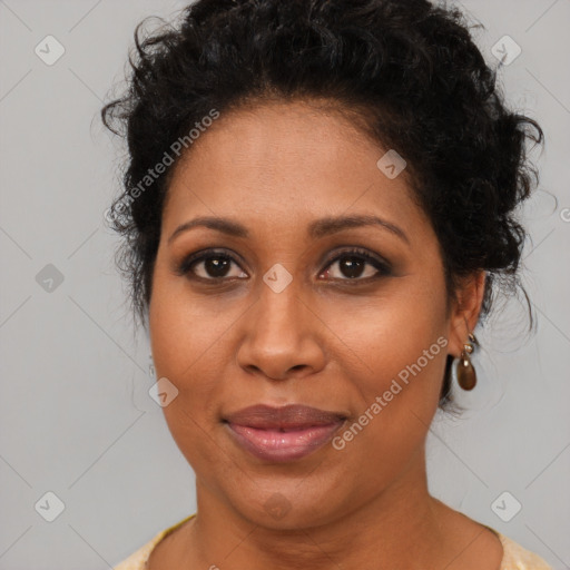 Joyful black adult female with medium  brown hair and brown eyes