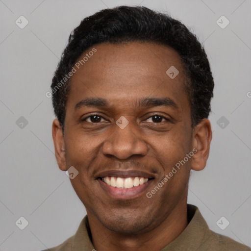 Joyful black adult male with short  black hair and brown eyes