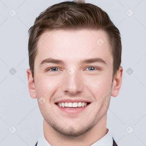 Joyful white young-adult male with short  brown hair and grey eyes