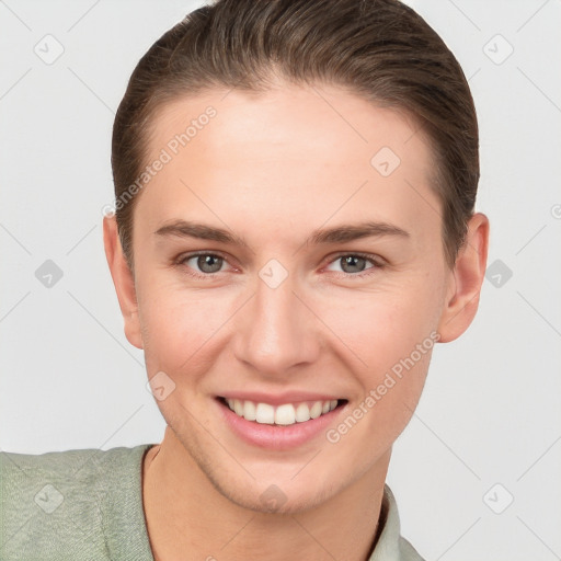 Joyful white young-adult female with short  brown hair and grey eyes