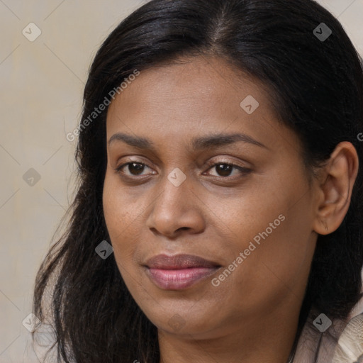 Joyful black young-adult female with long  brown hair and brown eyes