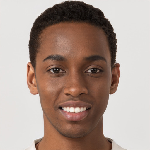 Joyful black young-adult male with short  brown hair and brown eyes