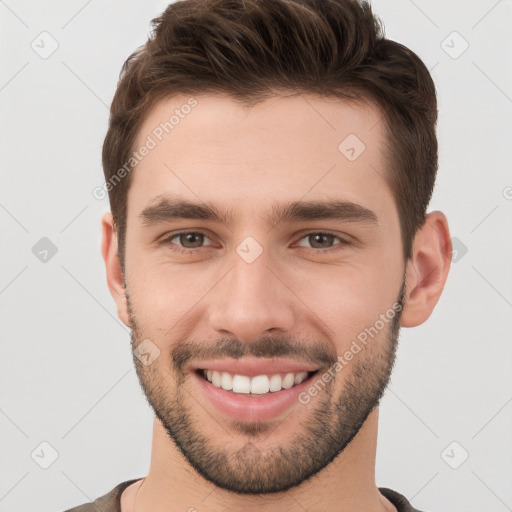 Joyful white young-adult male with short  brown hair and brown eyes