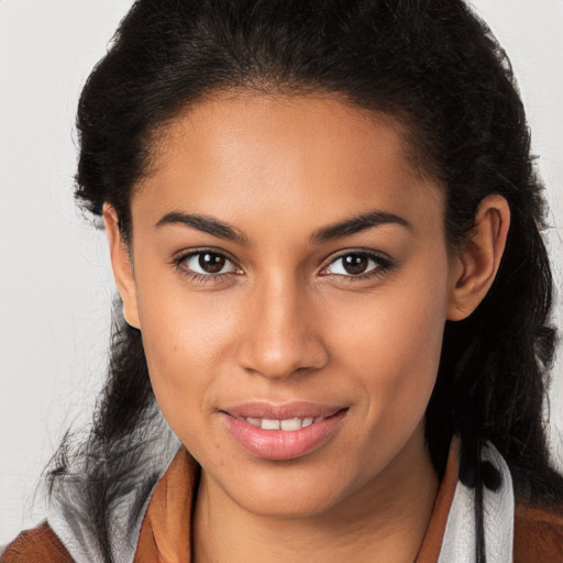 Joyful latino young-adult female with long  brown hair and brown eyes