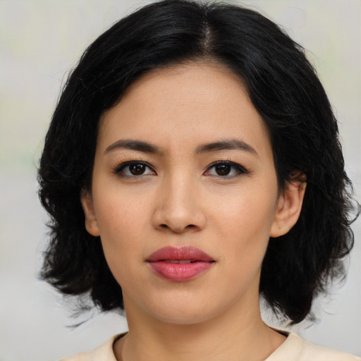 Joyful asian young-adult female with medium  black hair and brown eyes