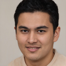 Joyful latino young-adult male with short  brown hair and brown eyes